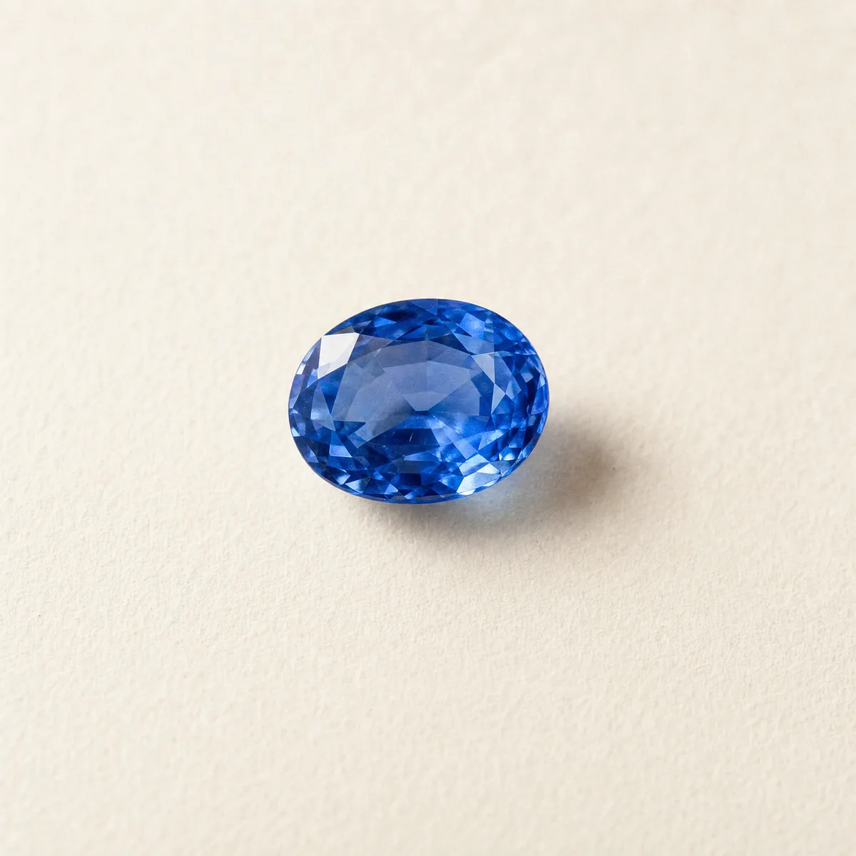 Oval-cut Ceylon blue sapphire on white gem paper